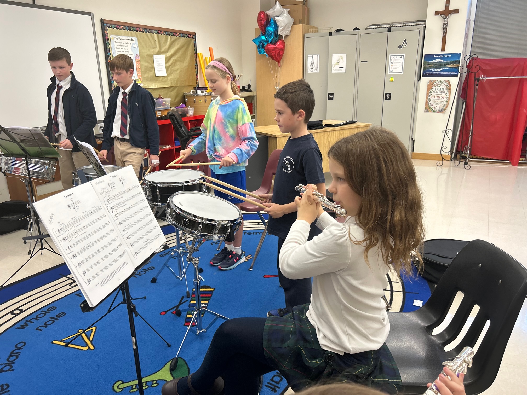Students of varying ages play instruments